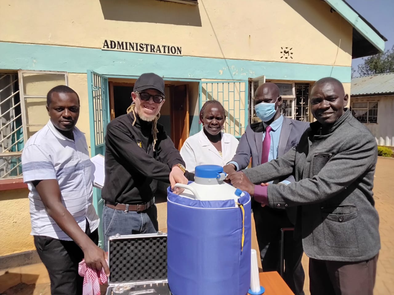National Council of Persons With Disability lead team in Trans Nzoia County led by Senior Program Officer Wilson Kabiro (Left) and Stephen Wafula (Second Left), hand over cryogenic equipment to the management of Kitale Sub County Hospital Chief Administrative Officer Joanes Nyongesa (Right).