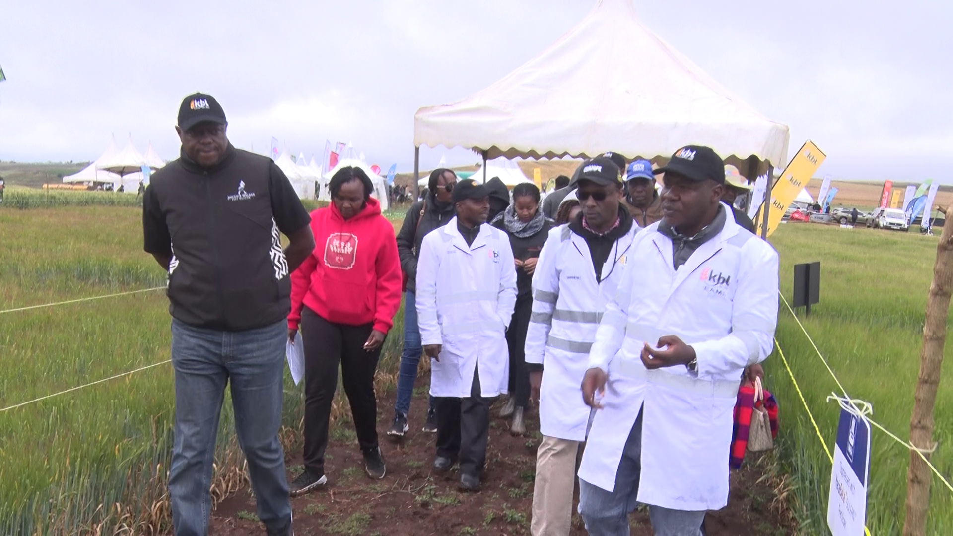Kenya Breweries Limited (KBL) Managing Director Mark Ocitti(in black coat) is shown the  new barley varieties on a field demonstration at Olokurto area in Narok North Sub County