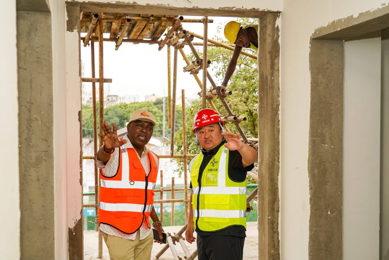 The Kenya Railway Corporation Managing Director, Mr Philip Maingi (L) and a constructor inspecting construction works at the Mombasa Central Railway Station.