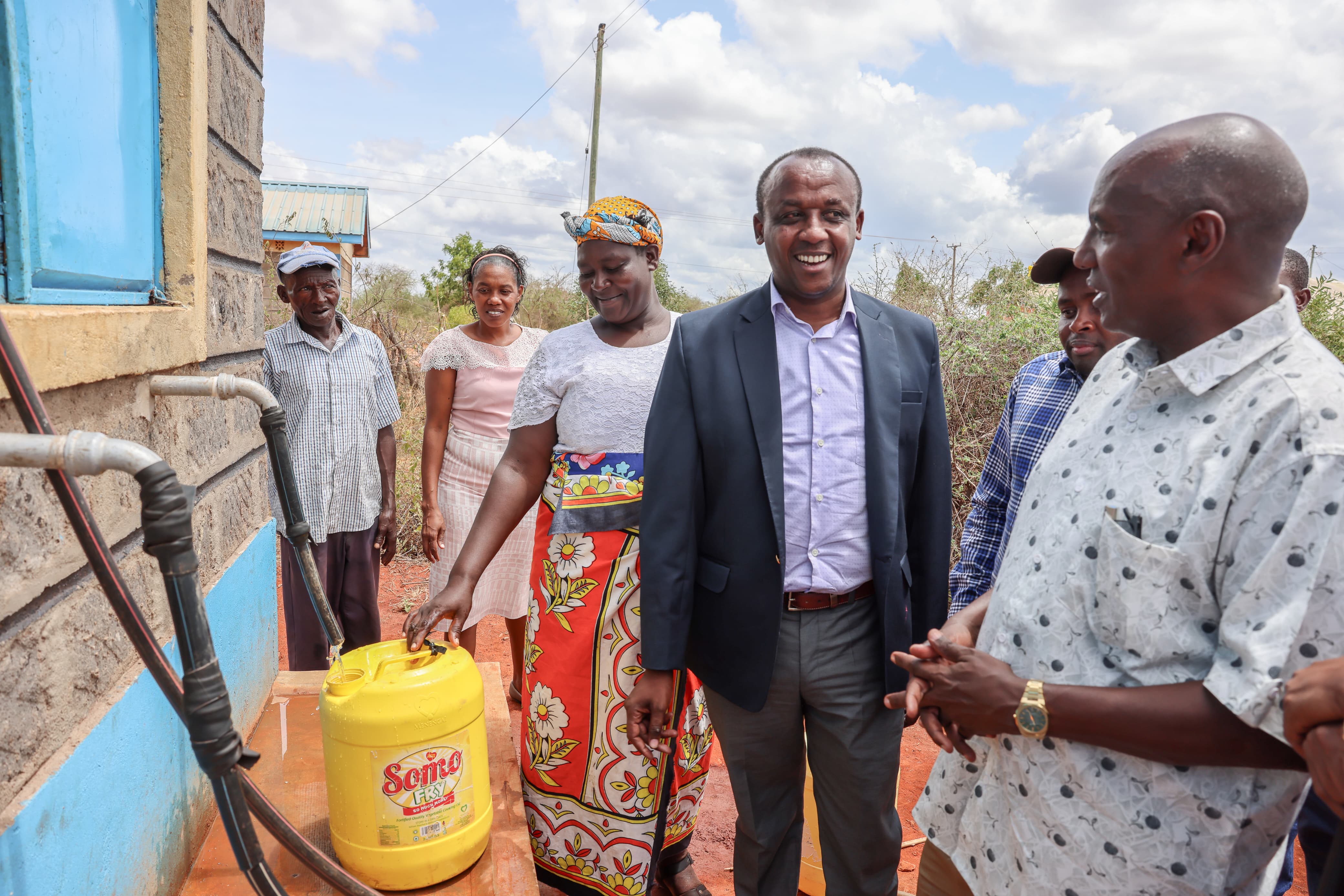 Governor Mutula (Left) and ASAL PS Harsama (right) at Kioski 1 at Yikitaa market where residents are able to access clean water for domestic use and watering of their animals