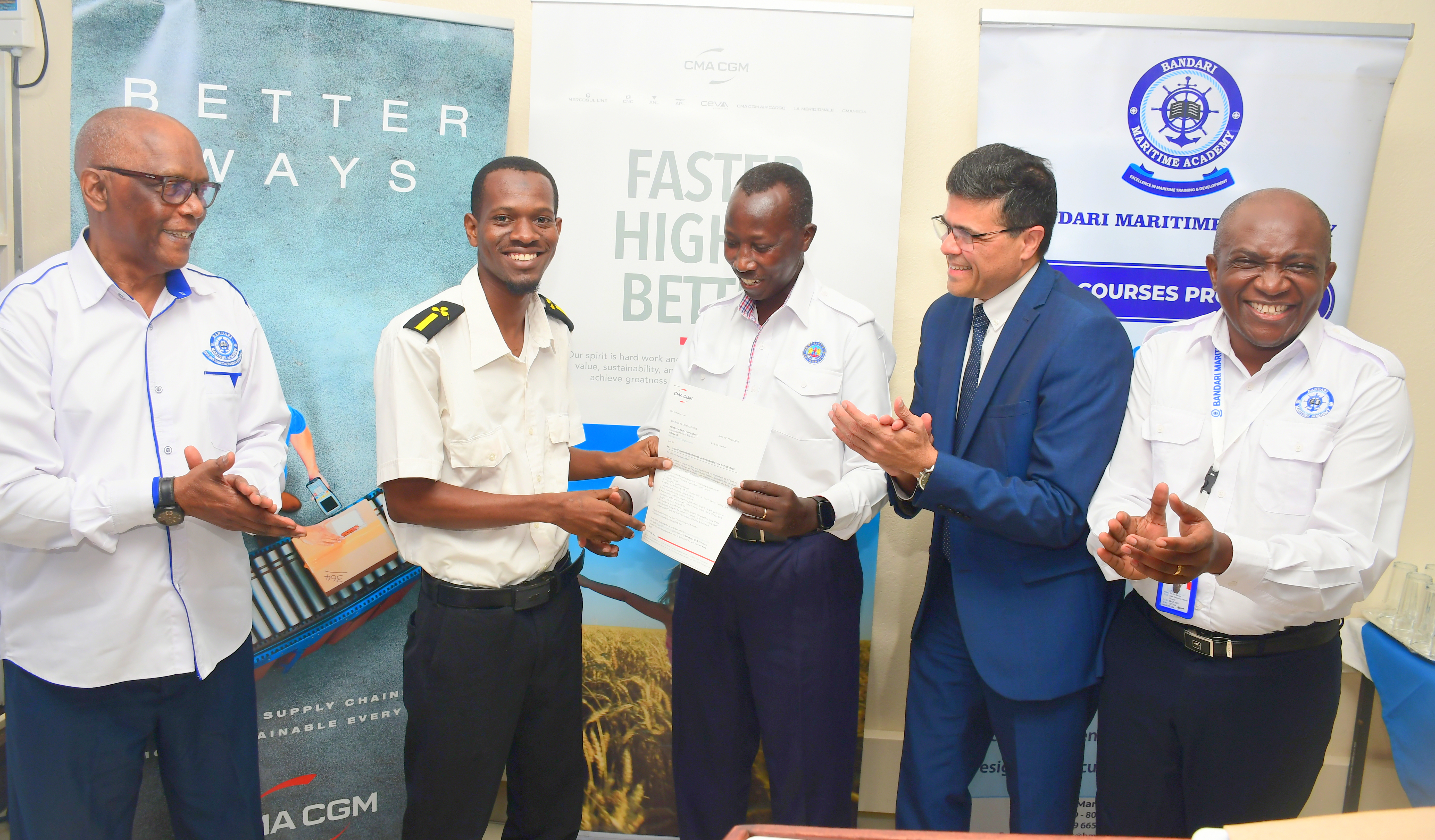 Bandari Maritime Academy (BMA) Chief Executive Officer (CEO) Dr. Eric Katana leads (R), CMA CGM Managing Director (MD) Naveen Prabhu (Second R) and BMA staff hand over an appointment letter to Kumbo Hamadi (Second L) during the sendoff ceremony of cadets for shipboard training with global shipping line CMA CGM at BMA Headquarters. 