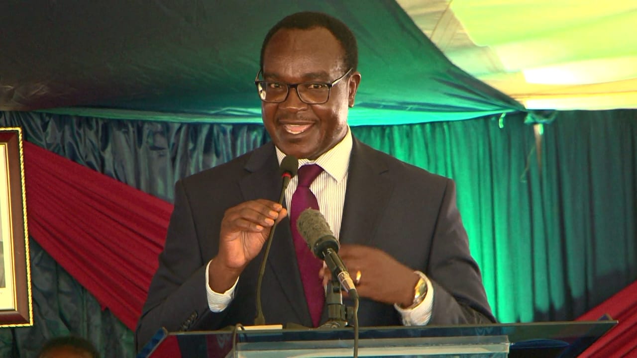 Education Cabinet Secretary Julius Ogamba addressing parents and students at Mary Hill Girls in Thika during a prize giving day.