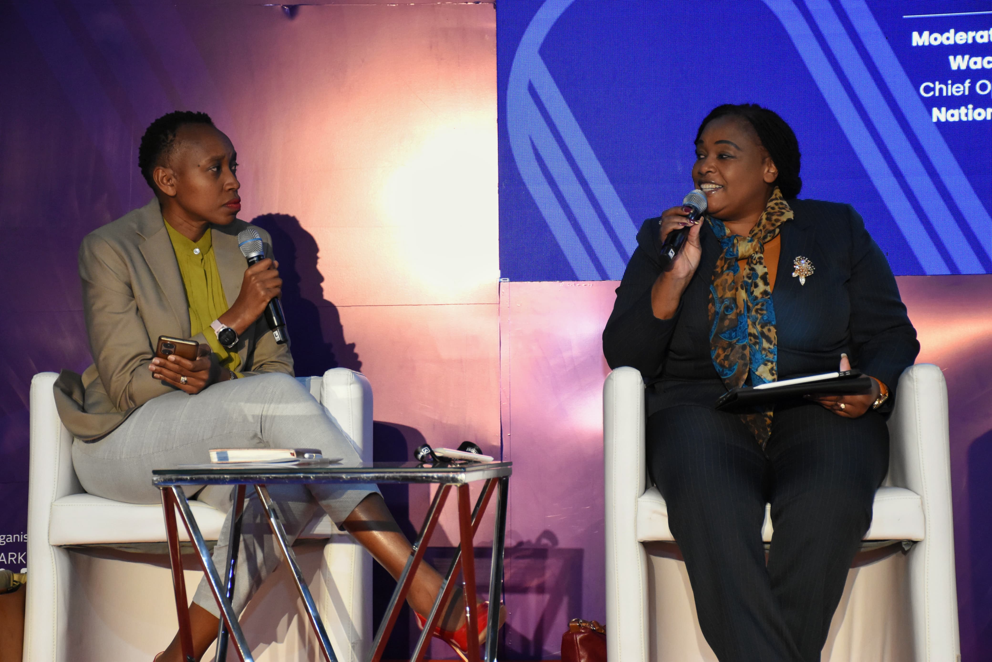 Secretary ICT E-Government-In-Charge of Systems in the Ministry of Information, Communications and the Digital Economy, Ms. Mary Kerema (Right), speaking during the Seamless East Africa 2025 event held at the Kenyatta International Convention Centre in the Company of Ms. Monicah Ndungu, Chief Operating Officer, Nation Media Group.