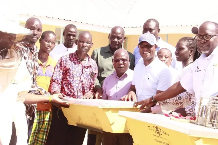 Principal Secretary for Agriculture Jonathan Mueke (third from right) accompanied by officers from State Department for Livestock during handing over of beehives to farmers in Turkana central and Loima sub county. PHOTO: PETER GITONGA 