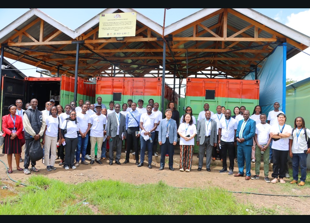 Investors and members of JKUAT at the mushroom growing site.
