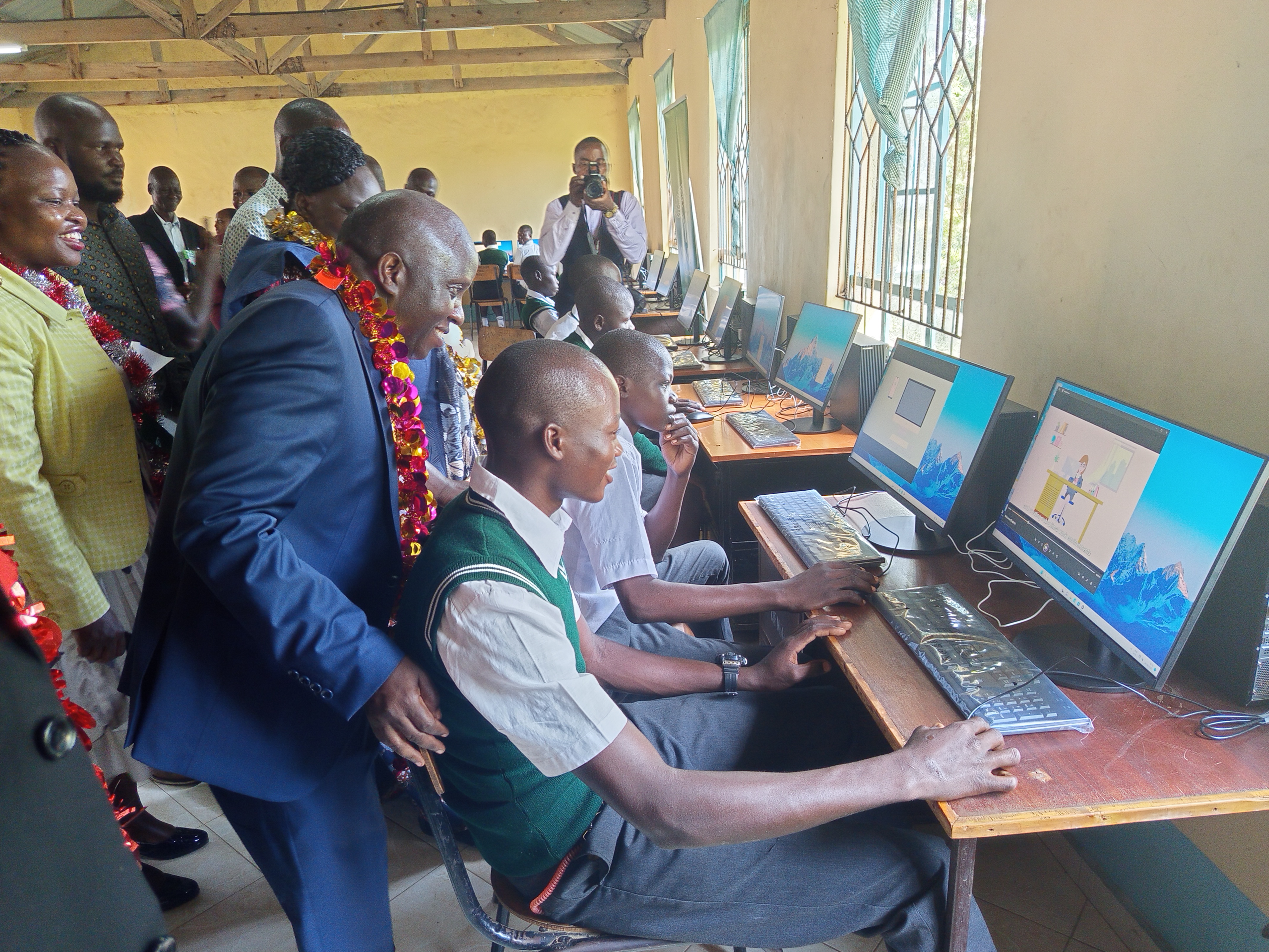 The PS engages in a dialogue with a student of Ngodhe Secondary School in Homa Bay in the newly commissioned digital laboratory. PHOTOS/SITNA OMAR