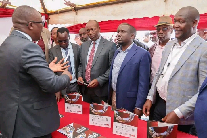 Investments, Trade and Industry CS Lee Kinyanjui, interacts with MSME exhibitors and listens to their presentations during the opening of the Investment Summit at Kiprugut Chumo Stadium in Kericho Town.