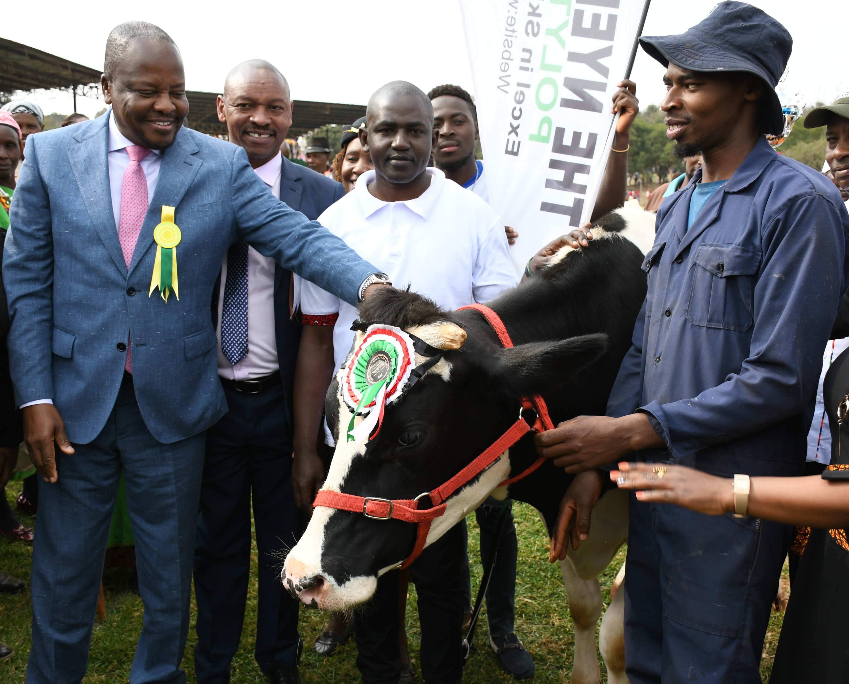 griculture and Livestock Development Cabinet Secretary, Mutahi Kagwe (L), admires one of the Friesian cows exhibited during the 57th edition of the Central Kenya, Agricultural Society of Kenya show at Kabiru-ini showground in Nyeri 
