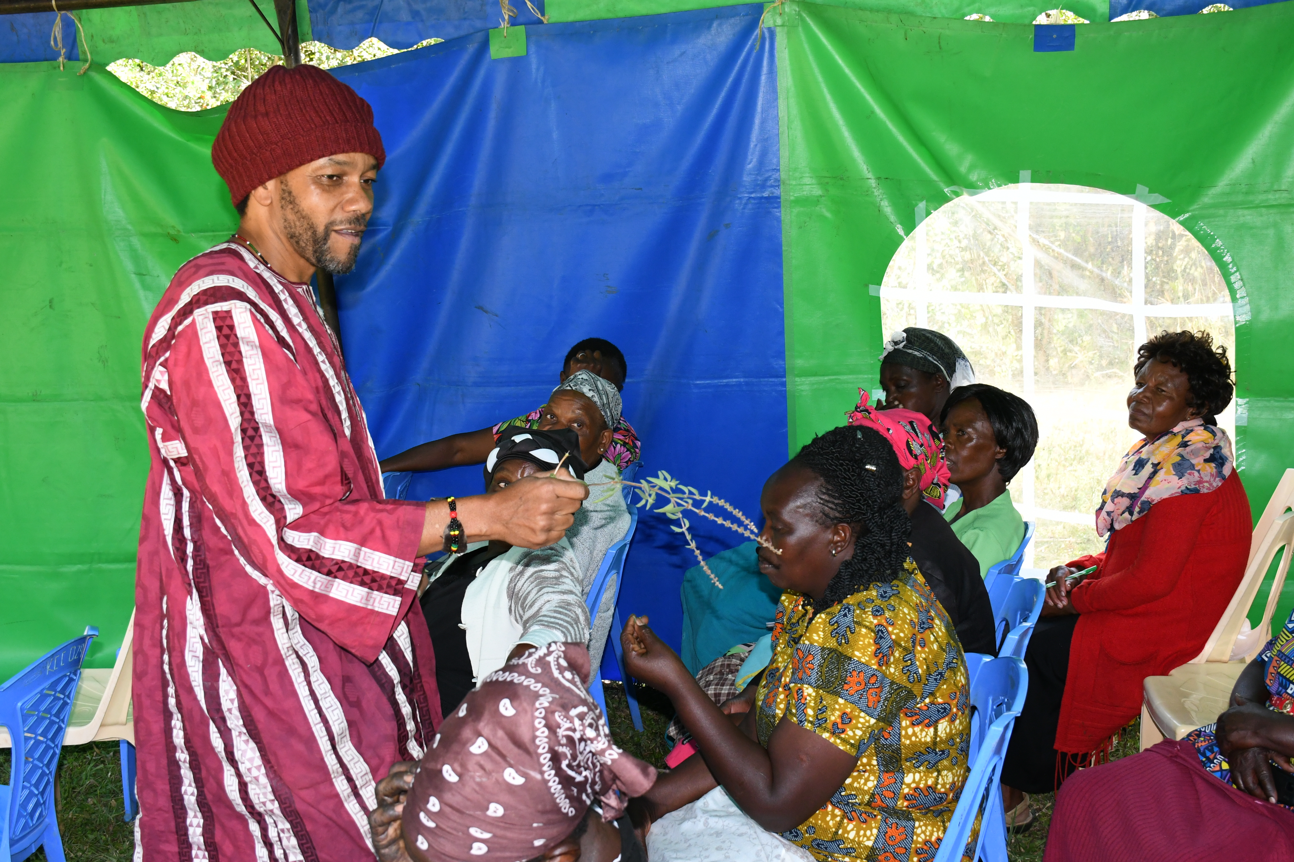  Gakiria Nderitu, a member of the team that is running the Technical Skills and Development Programme at JKUAT shows members of Wirugamie Karundas Widows Self Help Group a lavender branch. 