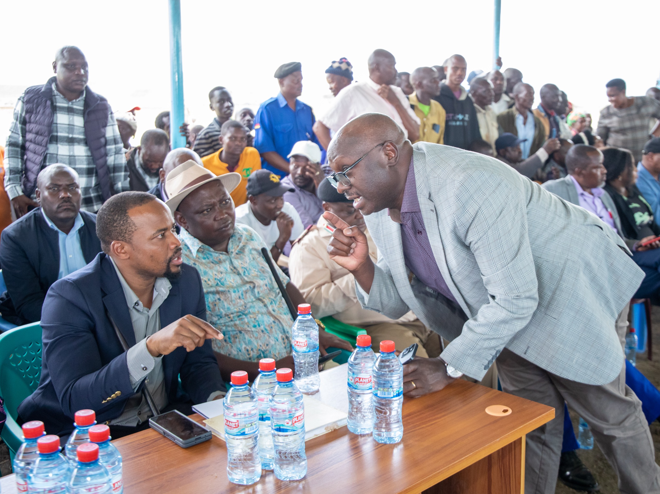  Lands PS Nixon Korir consults with Director for Adjudication and Settlement Kennedy Njenga during the baraza at Banita Settlement Scheme in Nakuru County