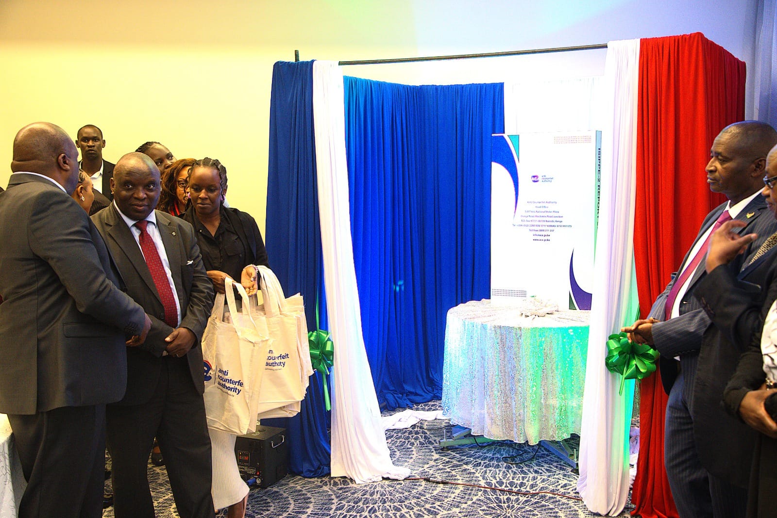 Industrialization Secretary Prof. Erastus Gatebe officially hands over the Report on the Second International Symposium on Intellectual Property Protection and Enforcement ISIPPE-2 to the Executive Director, Anti-Counterfeit Authority Dr. Robi Mbugua Njoroge