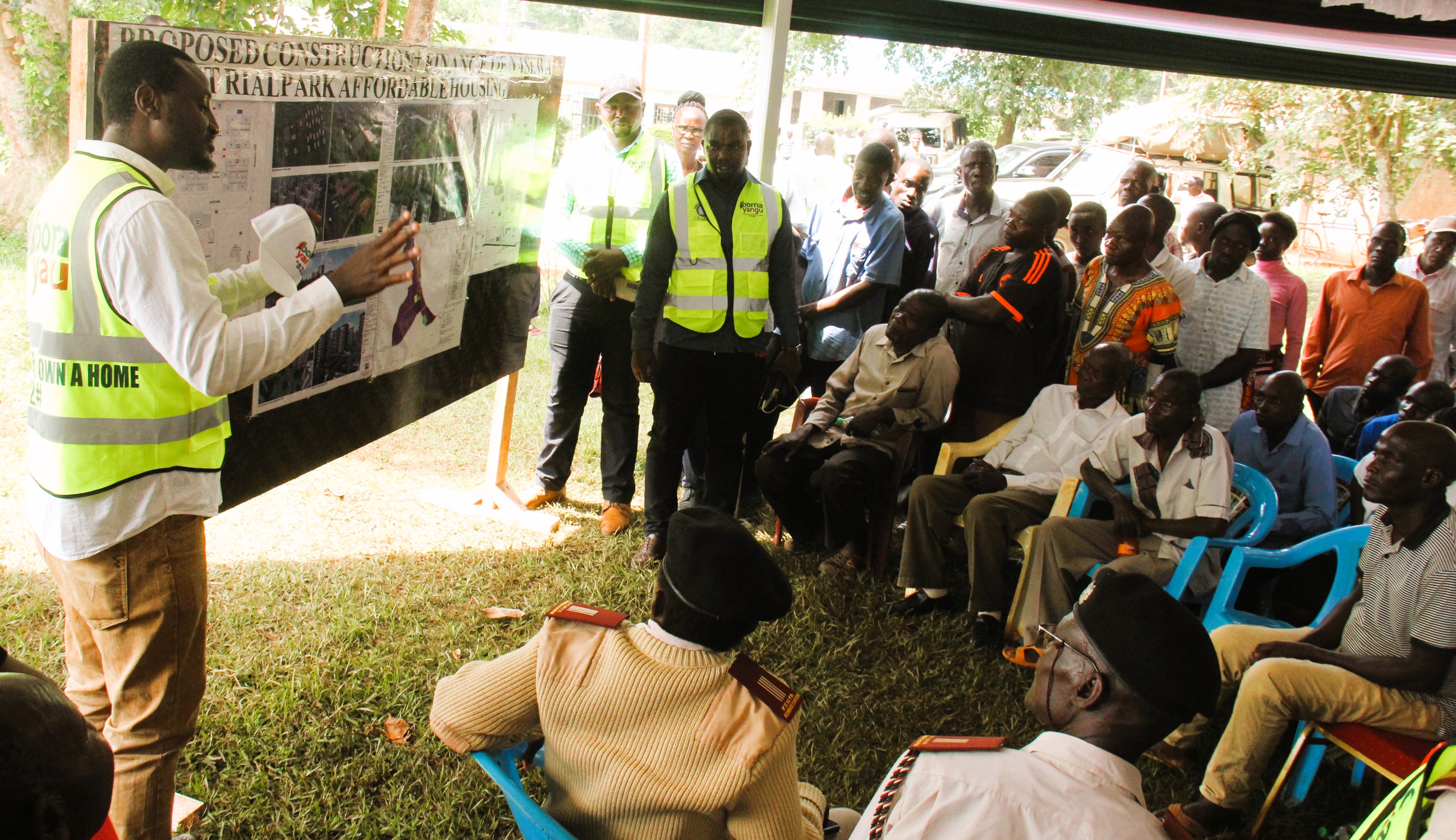 Residents of Nasewa, being taken through the architectural plan of the Nasewa industrial park housing project.