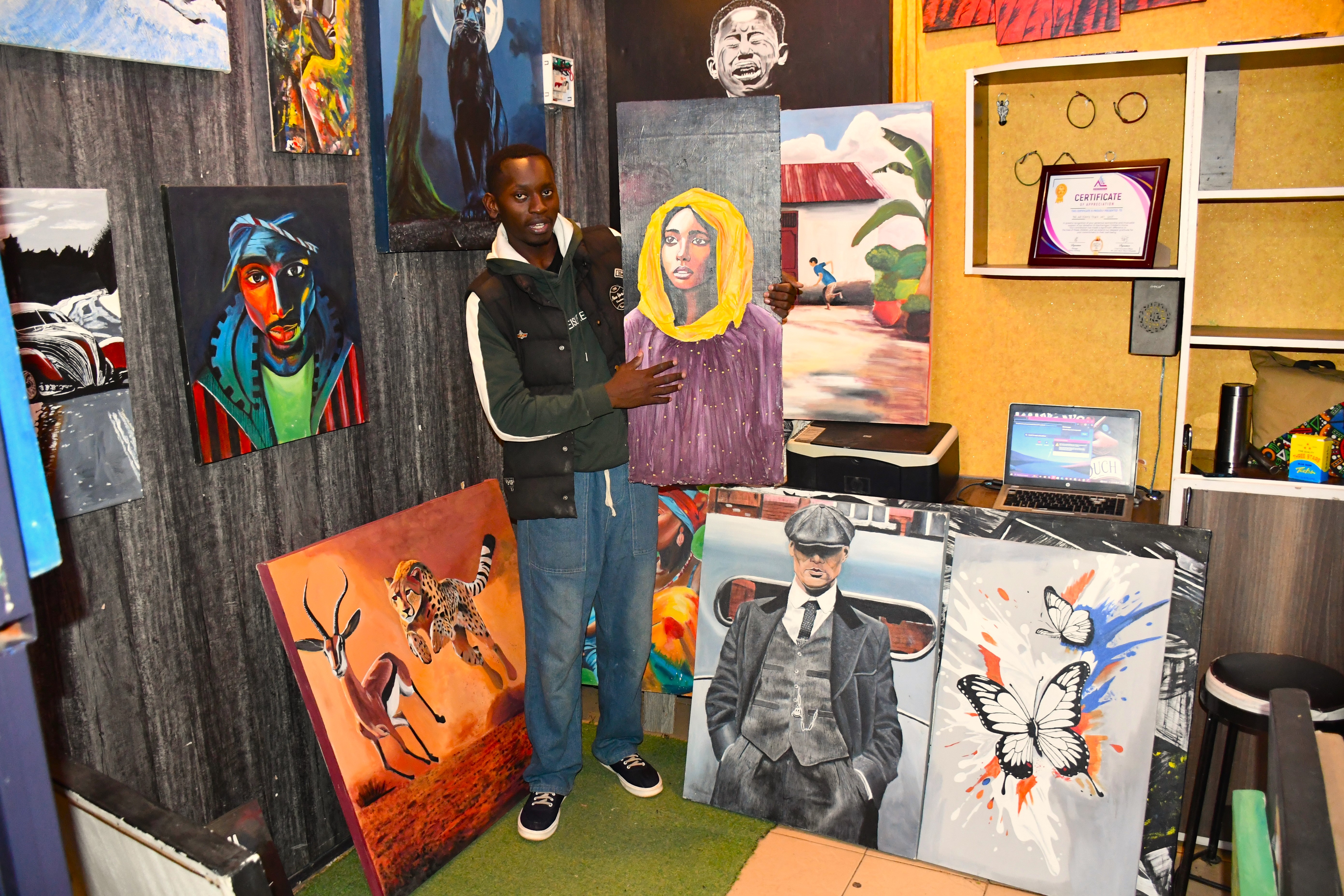 Kericho-based artist Jorim Muinda, aged 30 showcasing the colorful, handcrafted masterpieces at his shop in Simba Gate Mall, Kericho Town