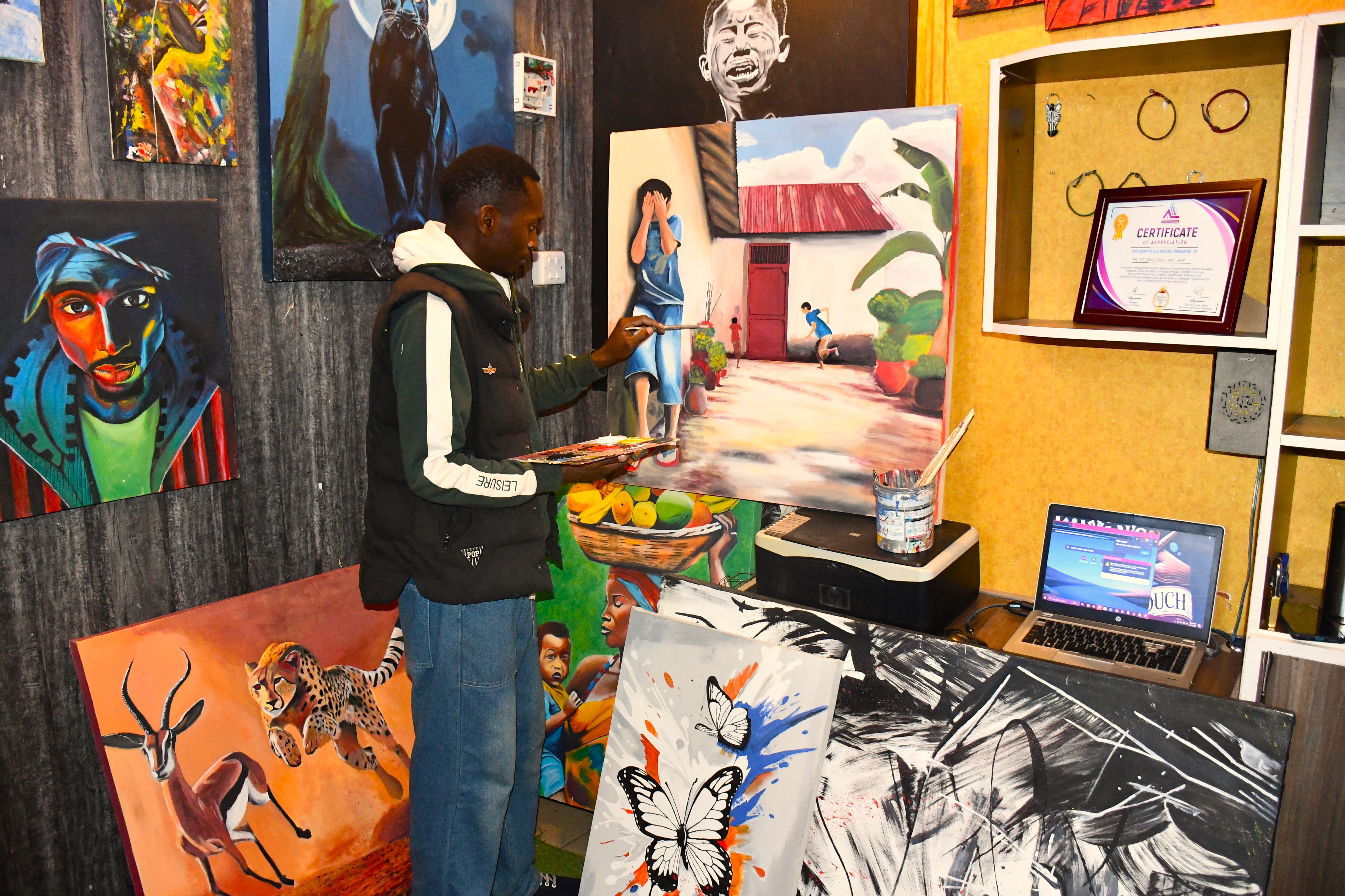 Kericho-based artist Jorim Muinda, aged 30 showcasing the colorful, handcrafted masterpieces at his shop in Simba Gate Mall, Kericho Town