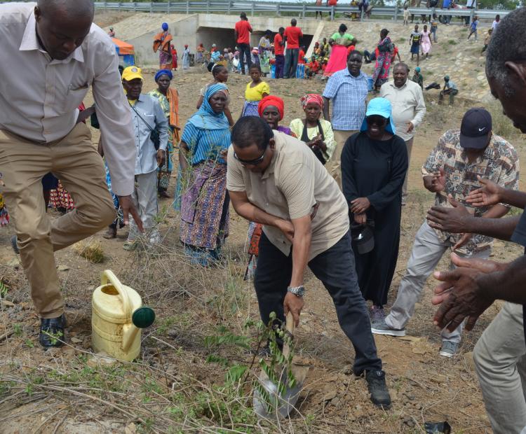 Water Resources Authority CEO Mohamed Shurie (centre) planting a tree during an inspection tour of Mwache Dam.