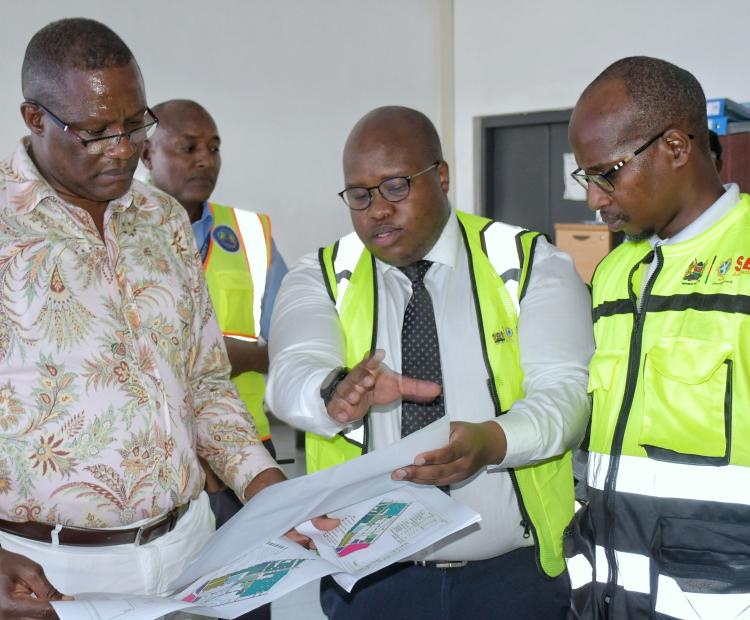 Deputy Chief of Staff in charge of Performance and Delivery Management at the Executive Office of the President, Mr. Eliud Owalo (left) engaging officers from the Special Economic Zone Authority on the Naivasha SEZ master plan