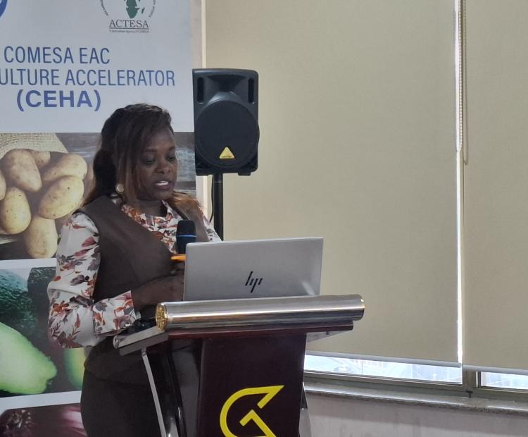 Ms. Caroline Chore- a Senior Trade Development Officer reading a speech on behalf of the State Department for Trade Principal Secretary (PS) Ms. Regina Ombam during the COMESA-EAC Horticulture Accelerator (CEHA) Regional Workshop.
