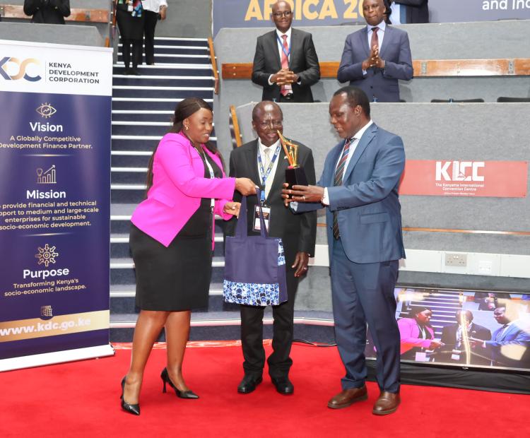 Principal Secretary (PS) for Industry, Dr. Juma Mukhwana (R) Kenya Development Corporation (KDC) Board Chair Sakwa Bunyasi and KDC CEO, Norah Ratemoh, having a chat at Next Frontier Africa 2025 summit at KICC. Photo/Jared Nyabuti