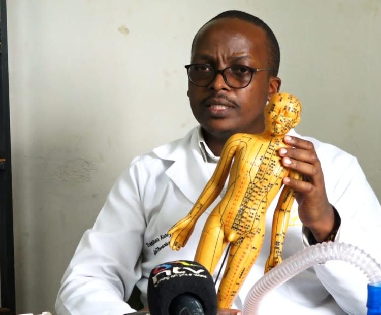 Steven Kimani explaining the 13 acupuncture points used in apitherapy during the interview