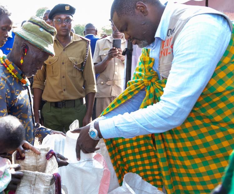 Cabinet Secretary for Public Servic,e Geoffrey Ruku, handing over foodstuffs to residents of Chemolingot, Tiaty Constituency during a government relief distribution exercise aimed at supporting vulnerable households.
