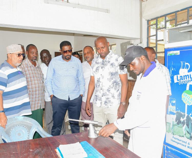 Principal Secretary for Investment Promotion Abubakar Hassan Abubakar (fourth from left, front row) together with his Cooperative counterpart PS Patrick Kilemi standing to his left joined officials of the Witu Livestock Cooperative Society for a group photo