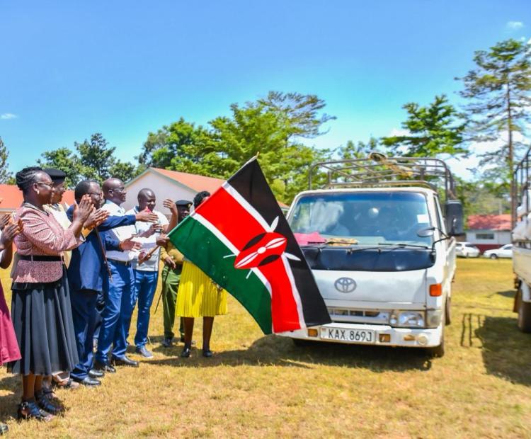 Principal Secretary for Economic Planning Bonface Makokha flagging off trucks with food donated to schools during the launch of secondary schools feeding programme in Busia PHOTO: RODGERS OMONDI
