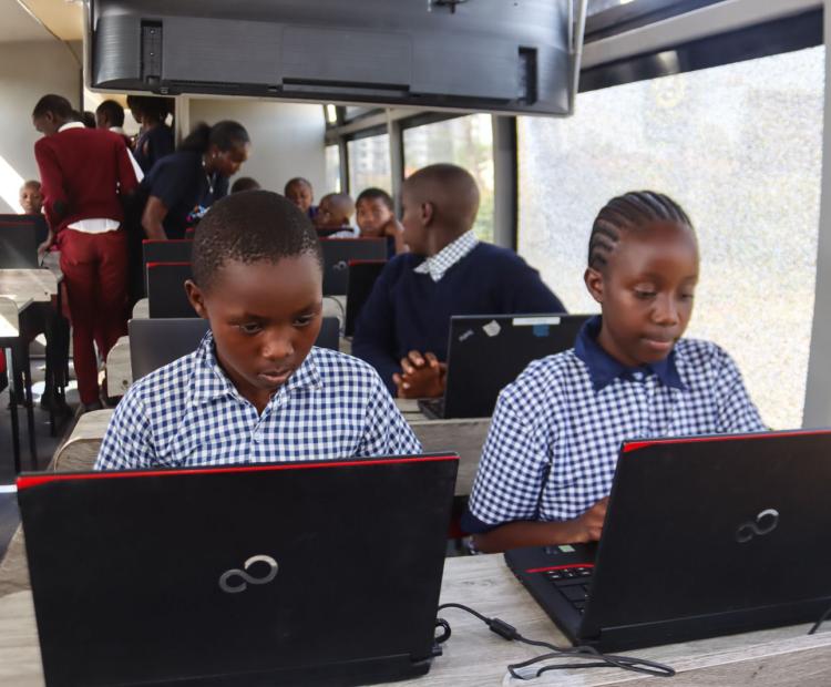  A student participates in a digital learning session aboard the Digi-AI Bus, a mobile classroom designed to deliver coding, AI and digital literacy skills to learners from underserved communities at the RFUEA Grounds