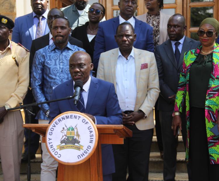 The Principal Secretary for Agriculture Dr. Kipronoh Ronoh Paul speaking in a press briefing flanked from back left; Uasin Gishu DCC Reuben Ogeda, Environment and Climate Change PS Dr. Festus Ng’eno, Governor Jonathan Bii Chelilim and Mariatu Kamara, International Fund for Agricultural Development (IFAD) Country Director.